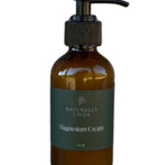 Amber bottle of Naturally Linda Magnesium Cream on a white background