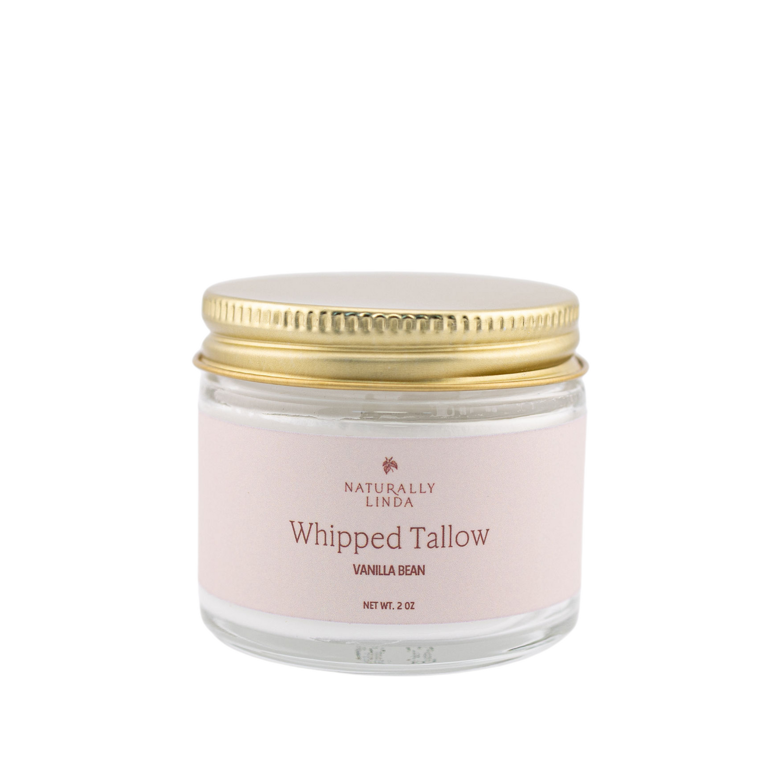 Glass jar with gold lid labeled 'Naturally Linda Whipped Tallow Vanilla Bean' on a white background