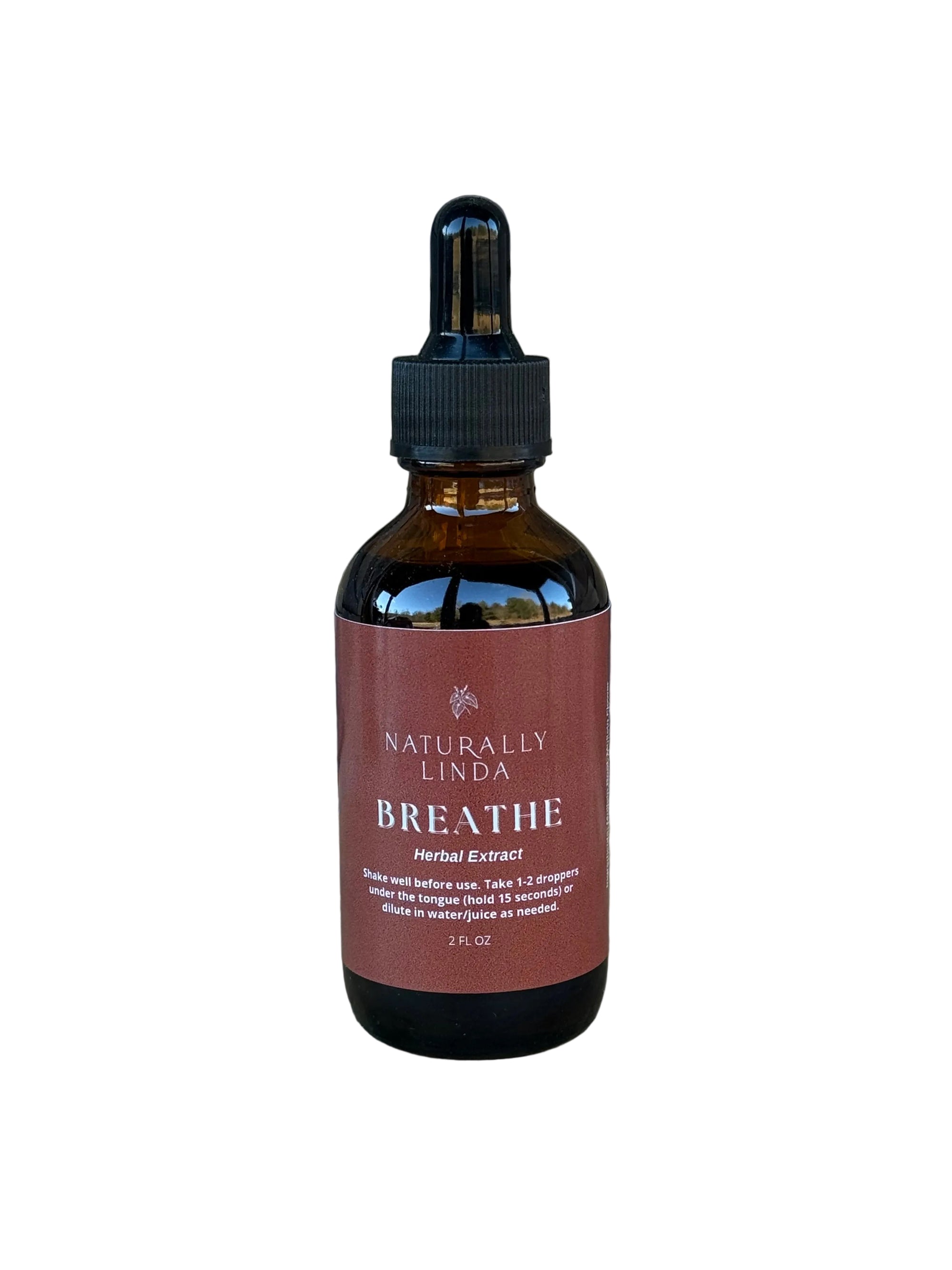 Bottle of 'Naturally Linda Breathe' on a stone surface