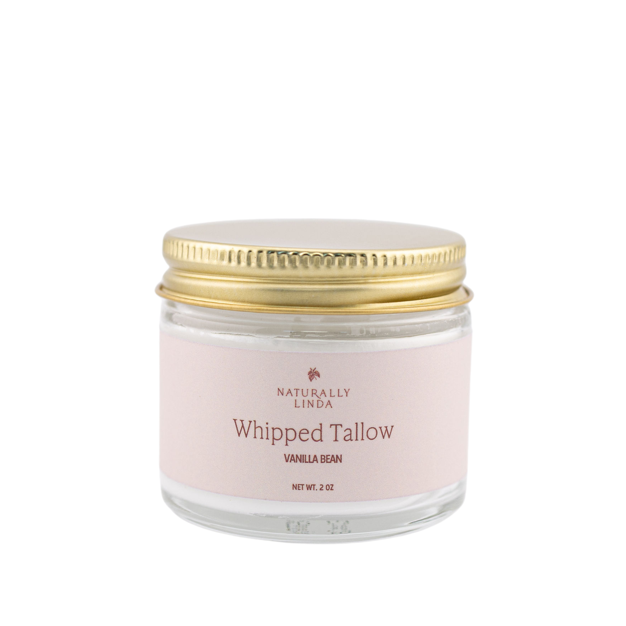 Glass jar with gold lid labeled 'Naturally Linda Whipped Tallow Vanilla Bean' on a white background