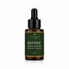 A 1 fl oz amber glass dropper bottle of Naturally Linda Batana+ Hair Growth Oil, featuring a dark green label with white text and a black dropper cap, set against a light gray background.