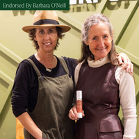 Linda and Barbara O'Neill standing together with a product, endorsed by Barbara O'Neill.