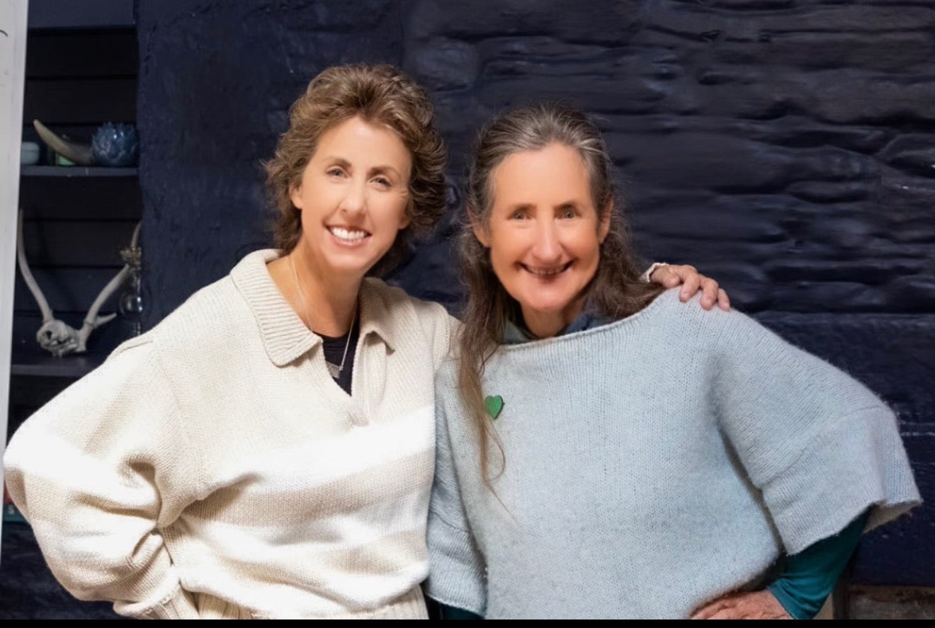 Two women, Naturally Linda and Barbara O'Neill posing together in front of a dark background