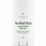 A white cylindrical salve stick container labeled 'Naturally Linda The Relief Ritual Arnica & Comfrey Salve Stick' on a plain white background.