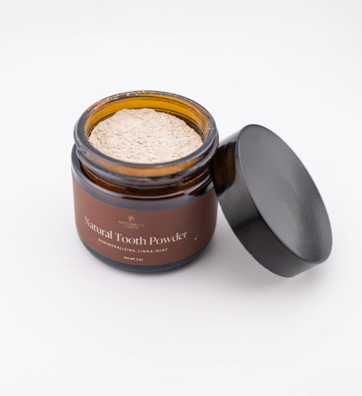 Jar of natural tooth powder cinna-mint with a black lid on a white background - Naturally Linda
