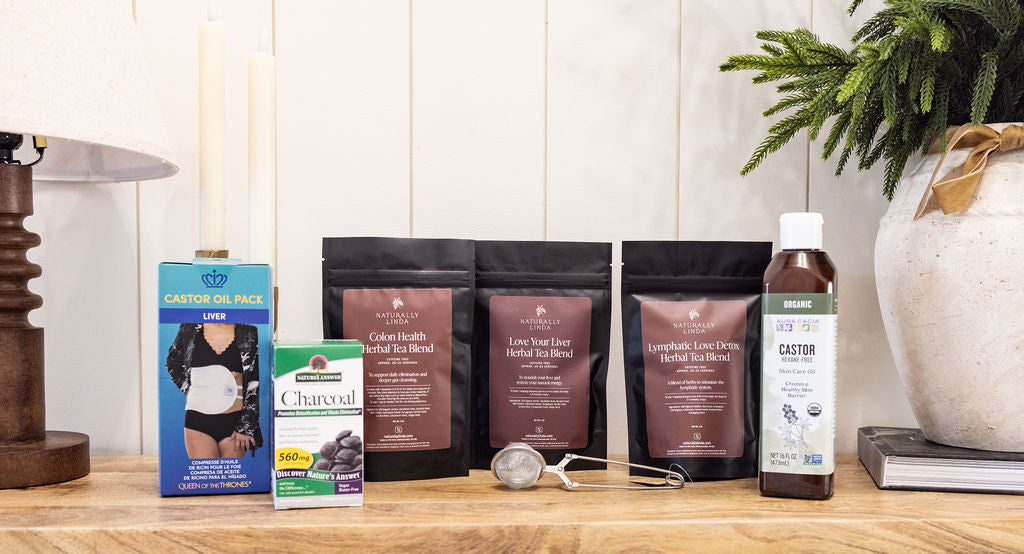Assorted health and wellness products on a wooden surface with a white wall and plant in the background.